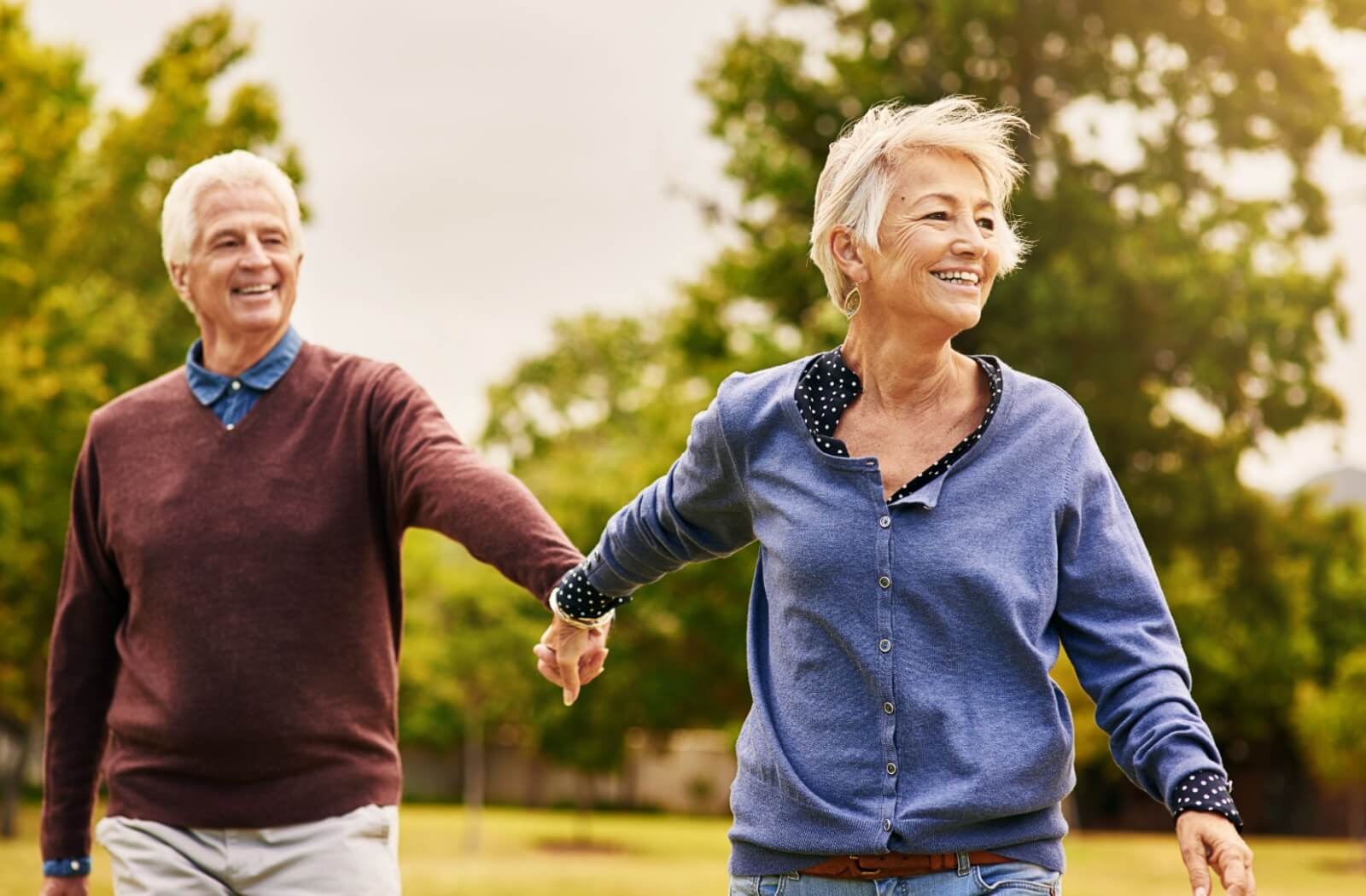 A mature couple goes out for a walk, each wearing a beautiful smile.