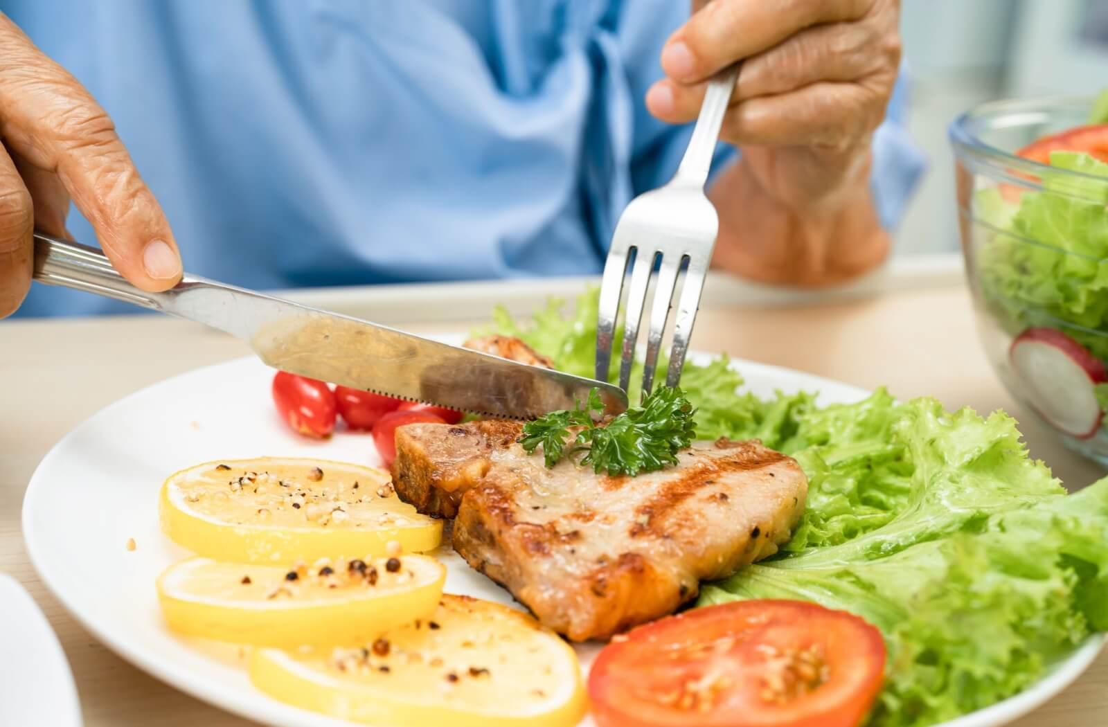 A close up of a senior eating healthy food for brain health.